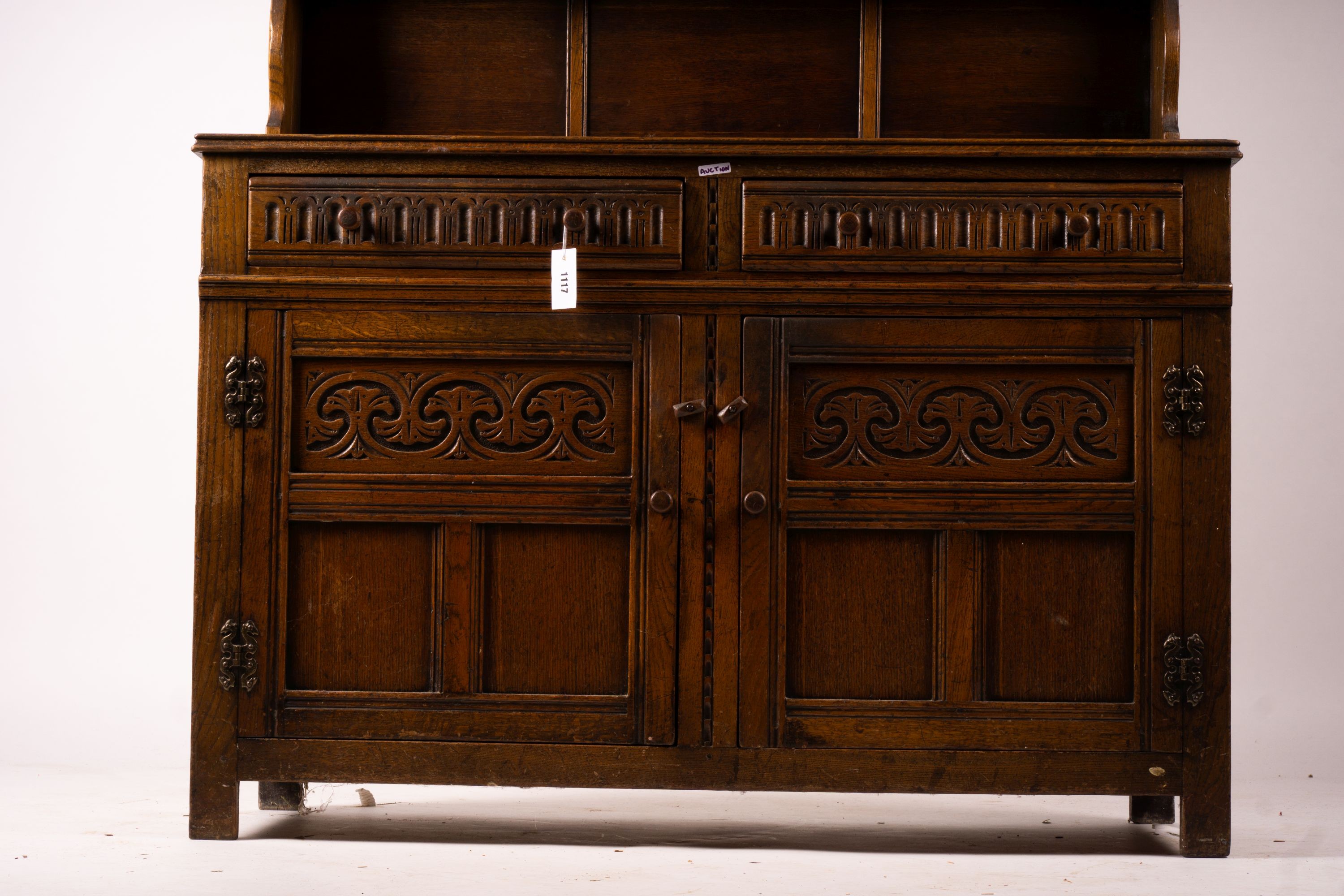 An 18th century style carved oak dresser, width 124cm, depth 46cm, height 175cm